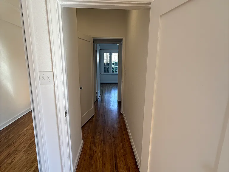 Hallway from Primary Bedroom to Laundry room, Bathroom and 1st Bedroom