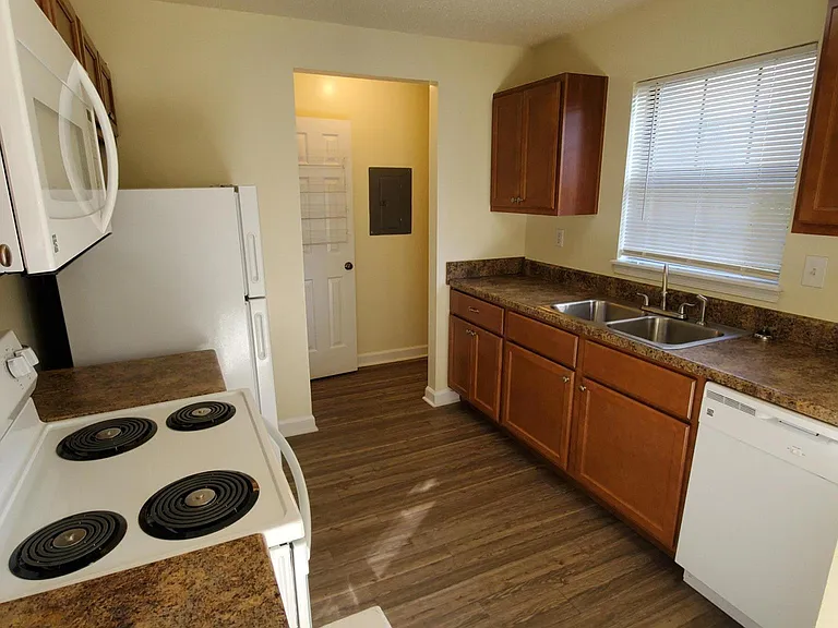 Kitchen with updated appliances, brand new kitchen cabinetry, brand new flooring, natural light!! plus a pantry!
