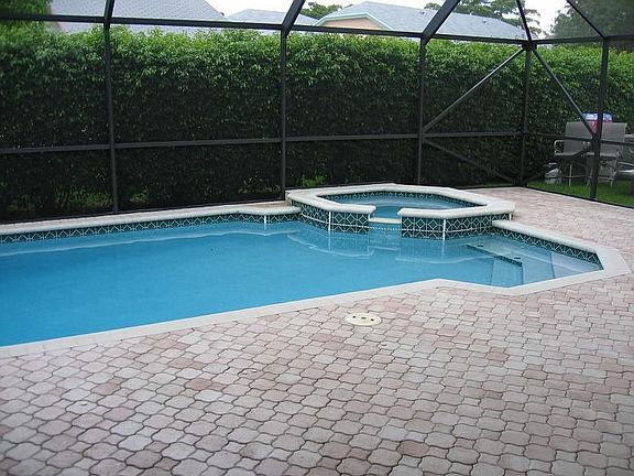 back screen in patio with heated pool and jacuzzi