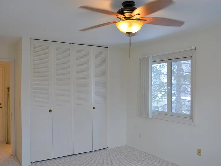 End Unit With Cross Breeze Windows, Ceiling Fan in Bedroom