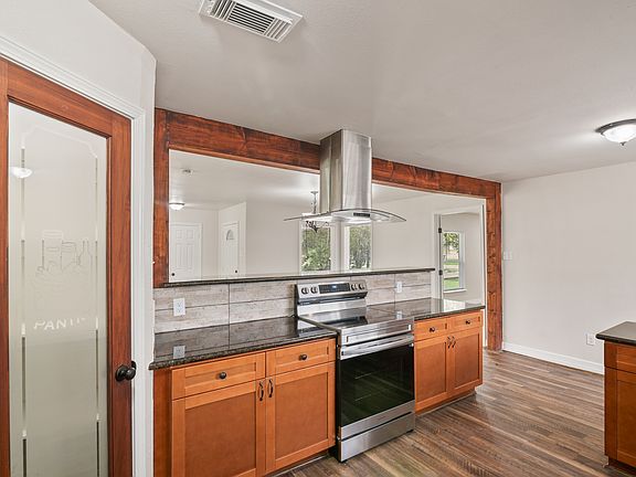 Sleek and beautifully updated kitchen featuring a striking wood-accented bar top