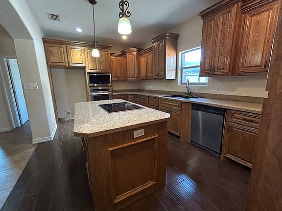 Glass cooktop, down draft vent, dishwasher, wall convection oven, wall microwave, garbage disposal, plenty of cabinet space, (NO FRIDGE)