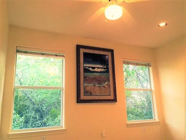 seondary bedroom has windows looking onto the trees