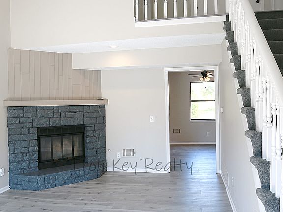 Spacious living room with fireplace, vaulted ceilings and easy access to the eat-in kitchen