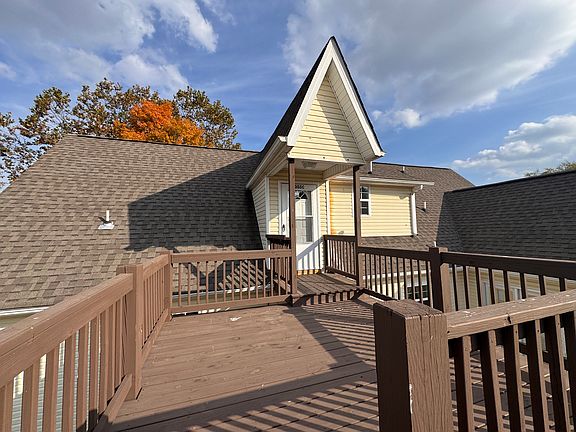 Here is photo of large deck at top of stairs and entrance into apartment.