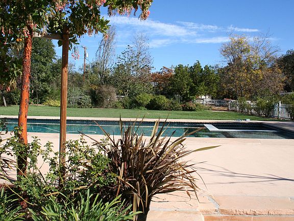 Magnificent rear grounds with pool, spa, outdoor kitchen, gardens