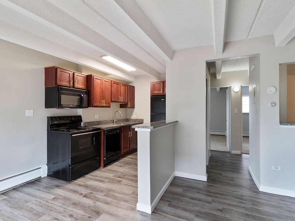 Spacious kitchen space featuring hardwood floors and all-black appliances