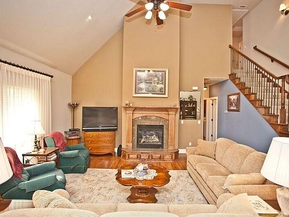 Tall ceilings with enclosed gas log fireplace as the centerpiece