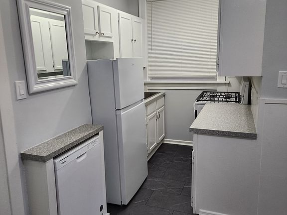 One side of the kitchen with brand new floors, counters, and all new appliances including dishwasher