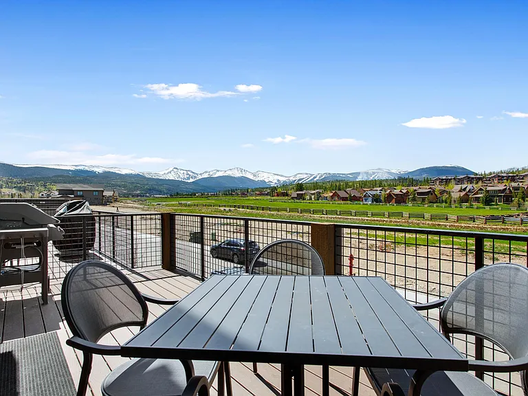 Second level patio with table and natural gas bbq