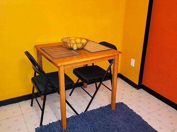 Kitchen furnished with kitchen table and chairs.