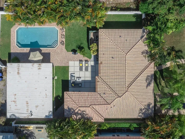 Double sized private fully fenced lot with patio, outdoor dining table, and heated pool.