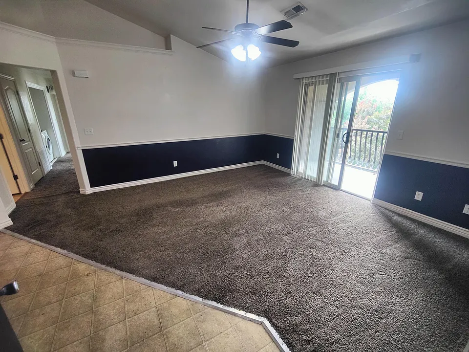 Spacious front room, vaulted ceilings, and kitchen.