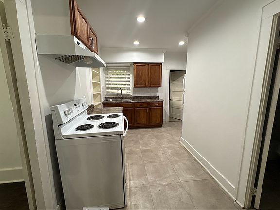 Kitchen - unit comes with a fridge. Past the kitchen is a dedicated laundry room.