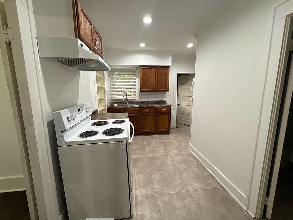 Kitchen - unit comes with a fridge. Past the kitchen is a dedicated laundry room.