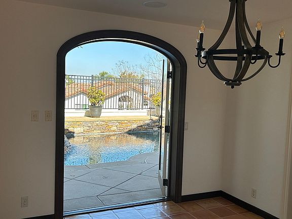Beautiful arched doors open to the backyard