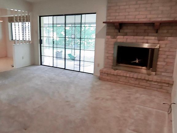 Second living area with fireplace and patio door