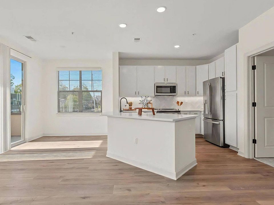 Bright Apartment Layout Featuring White Kitchen and Wood Floors
