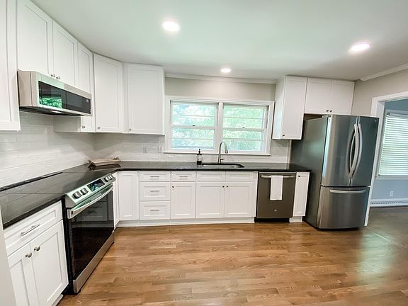 Brand new kitchen with granite counters, soft close cabinets, and stainless steel appliances