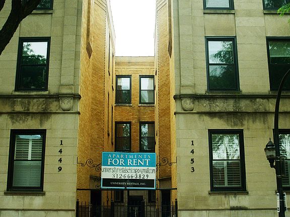 classic Chicago greystone courtyard building on a quiet tree-lined street
