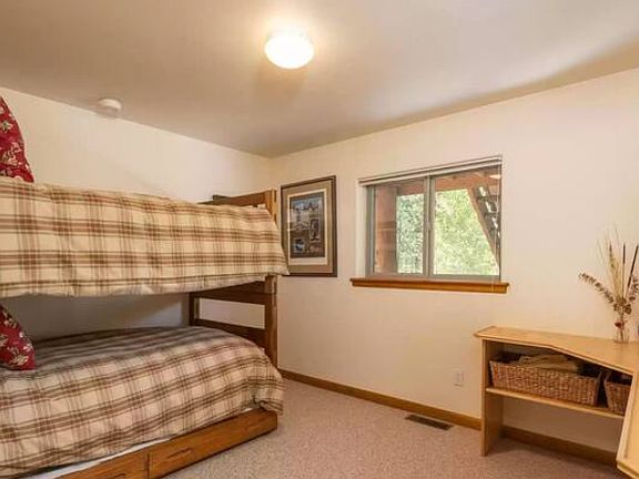Downstairs bunk room with two beds and a trundle pull out