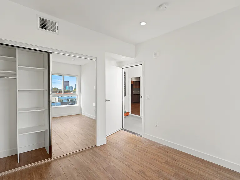Bedroom with Mirrored Closet with Shelving