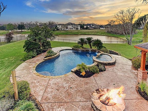 So much to love here! Sparkling pool with spa and waterfall, gas fire pit, all situated on a one-acre waterfront lot!