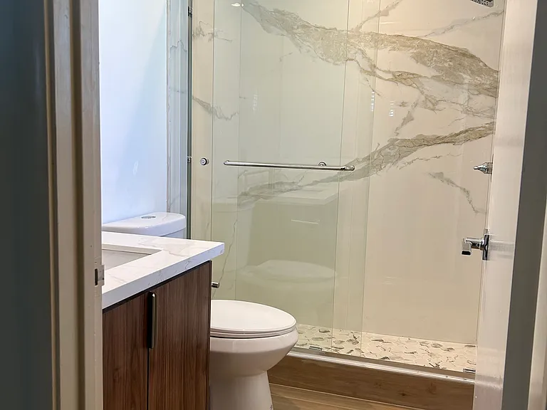 Master Bath with tile floors, and quartz vanity top and shower walls