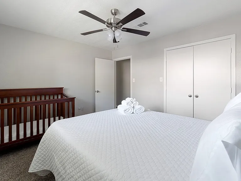 Bedroom featuring a closet, a ceiling fan, and carpet flooring