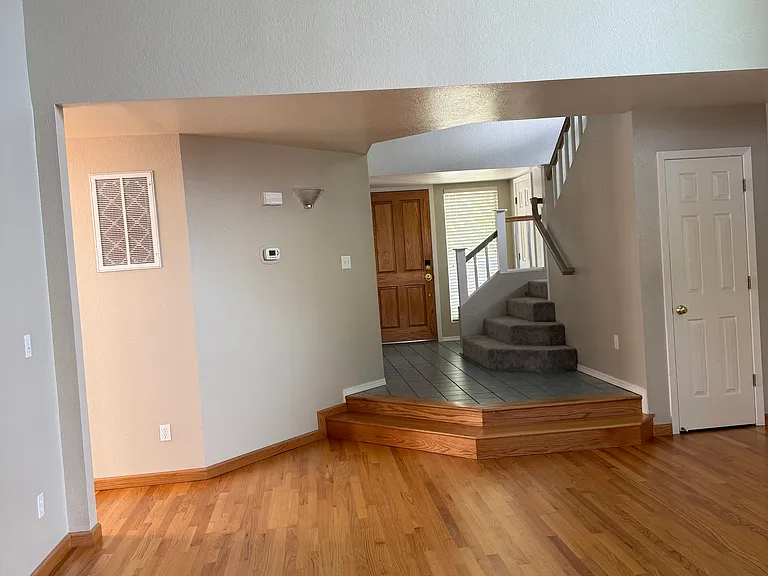 LIVING ROOM WITH ENTRY AND WALK TO UPSTAIRS BEDROOMS
