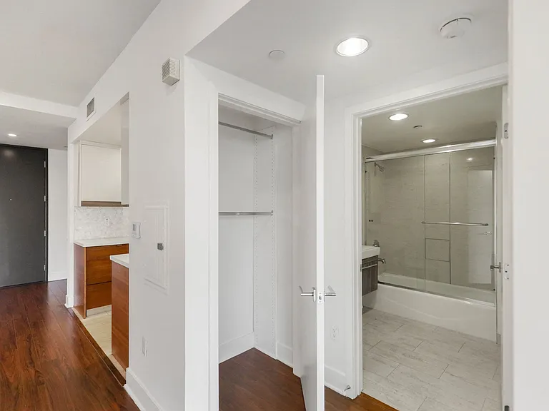 Hall Closet and Bathroom with a Bathtub