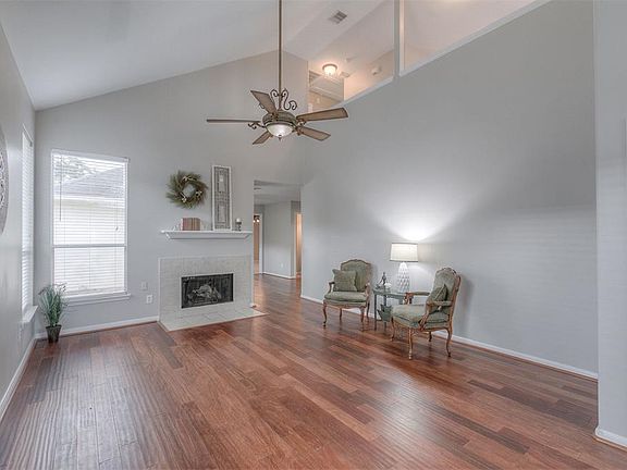 Spacious living room right as you enter the home. The fireplace really adds an element of charm to the space.