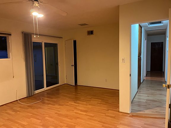 Master bedroom; door in rear of photo opens into a bathroom while the sliding glass doors open to the back patio.