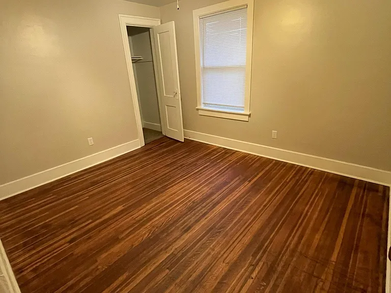 Another sizable bedroom with a window overlooking the side yard.