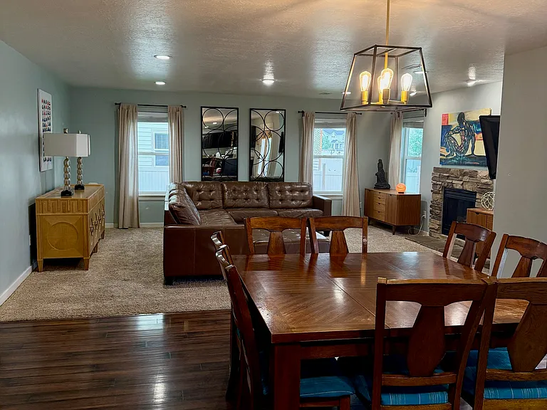 Dining room overlooking light filled family room with fireplace.