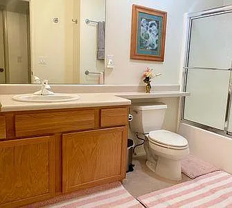 Bottom floor full bath with adjacent linen closet.