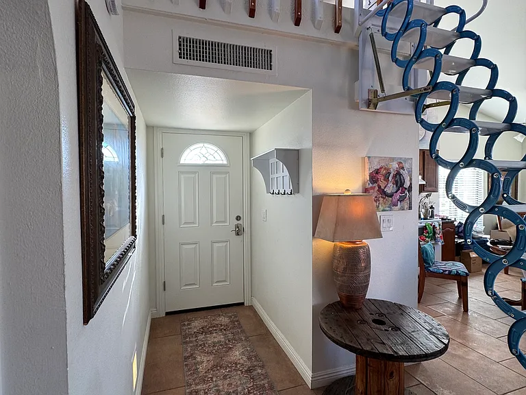 Front door and loft showing pull down loft stairs.