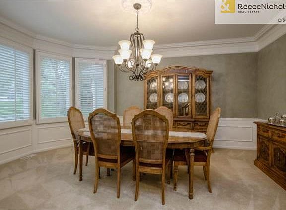 DINING ROOM WITH EXQUISITE MOLDING AND WOOD TRIM