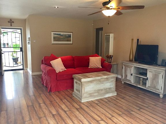 Screen entry for ocean breezes opens to living area overlooking yard