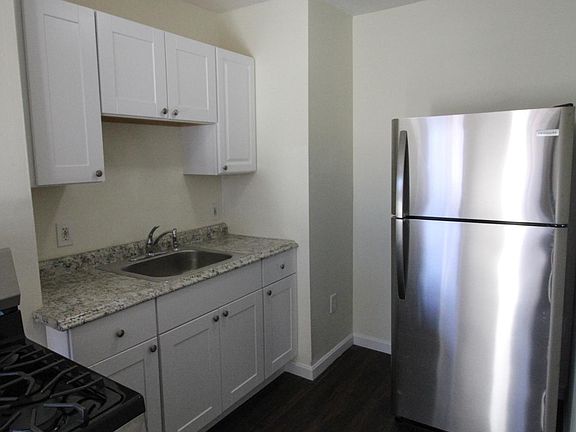 Kitchen with new, stainless steel stove and refrigerator
