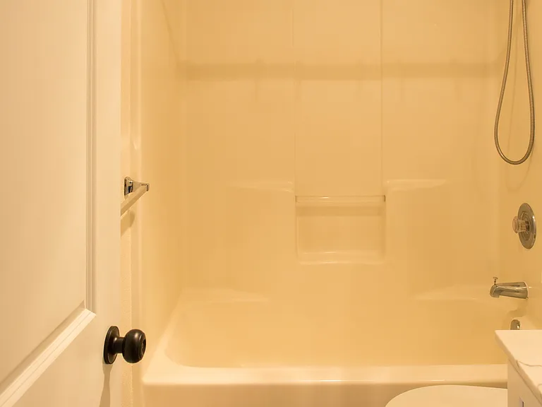 Shared full bathroom conveniently located near both second-floor bedrooms, featuring bright updated finishes and functional layout.