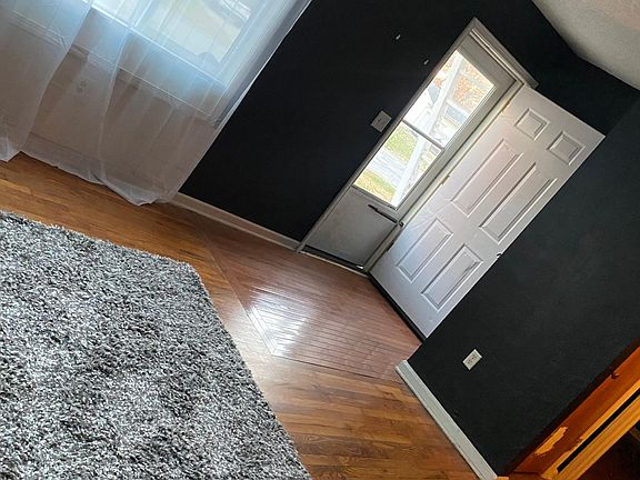New Paint & Curtains, with Beautiful Hardwood Floors in Living Room.