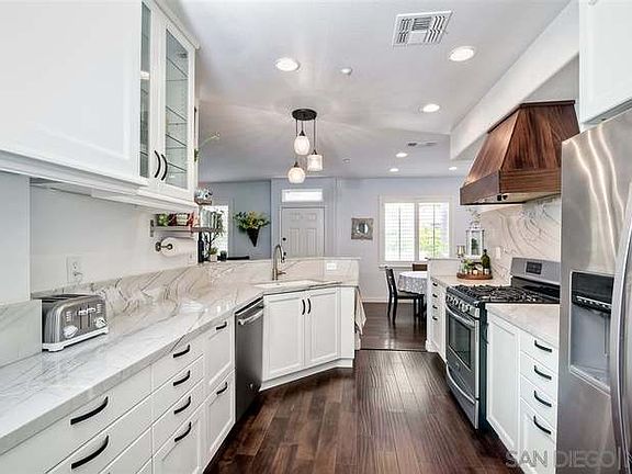 Remodeled kitchen with view to dining area and family room