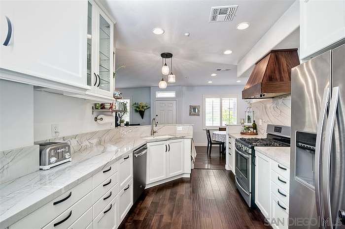 Remodeled kitchen with view to dining area and family room