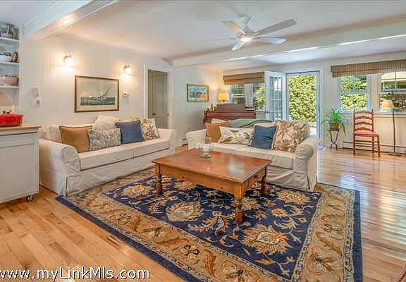 Main living room with open floor plan opens to rear deck