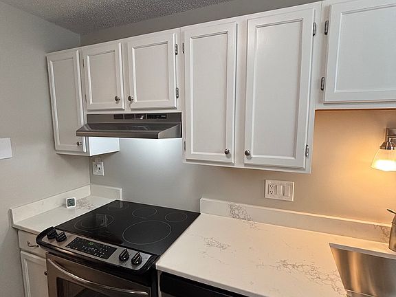 Kitchen with oven/cooktop, and dishwasher.