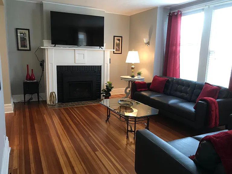Living room leather furniture , 65" tv, & gas fireplace with remotes.