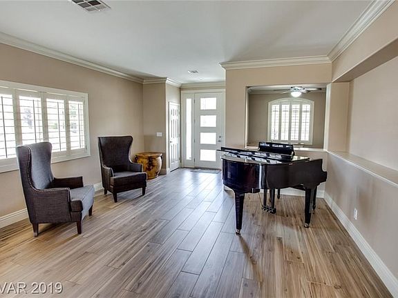 Enter into formal living room with office/den to the left as you enter.  Home features gorgeous ceramic plank tiles, plantation shutters, two-tone paint and crown and base molding throughout.