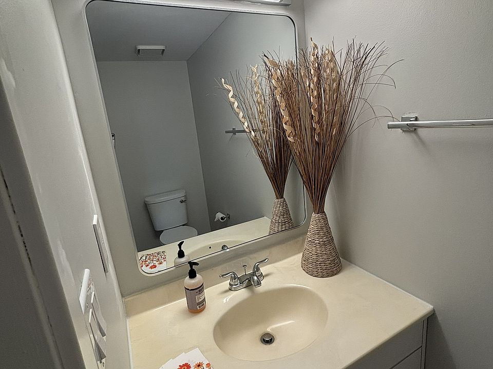 Fully renovated bathroom with a stylish mirror and ribbed light bar (1/2).