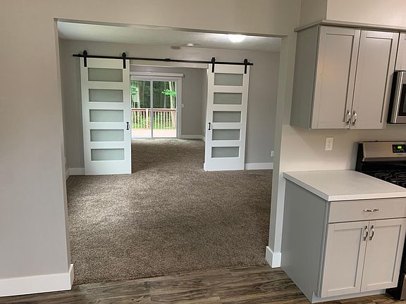 Looking from Dining area through living are and through the Family Room to the sliders and deck